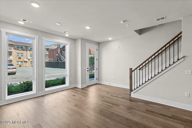 a view of an entryway with wooden floor
