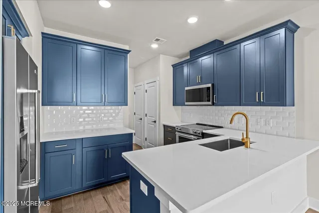 a kitchen with wooden cabinets a sink and a stove