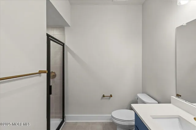 a white toilet sitting next to a bathroom sink