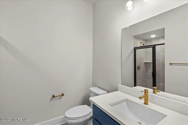 a bathroom with a sink toilet and mirror