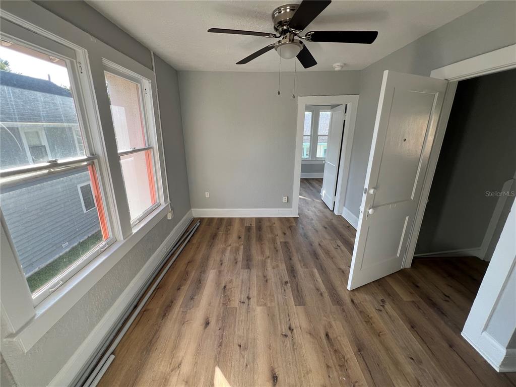 713 Davis Street, Unit 2 Daytona Beach, FL 32118 - Photo 4 of 10 a view of a hallway view with wooden floor and staircase