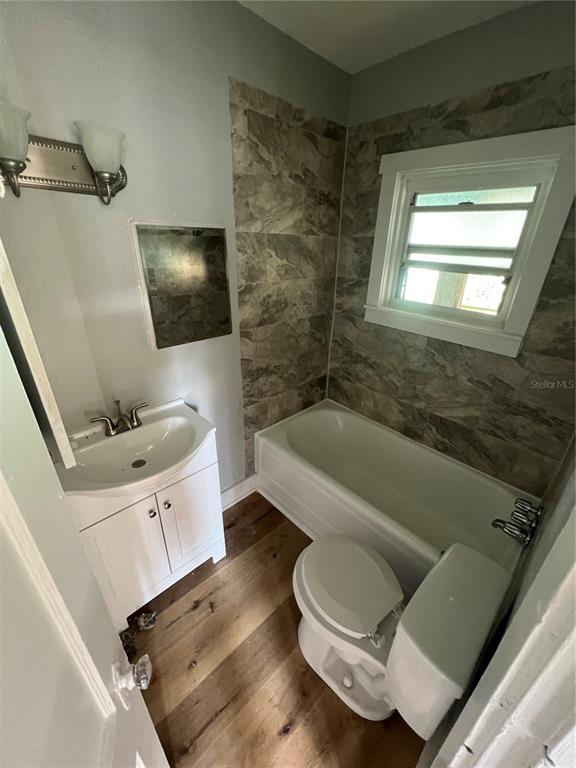 713 Davis Street, Unit 2 Daytona Beach, FL 32118 - Photo 7 of 10 a bathroom with a sink a bathtub and a flat screen tv
