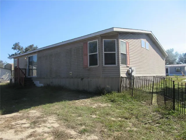 a view of a room with a window and wooden walls