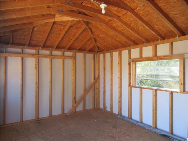 a view of a room with wooden floor and a window
