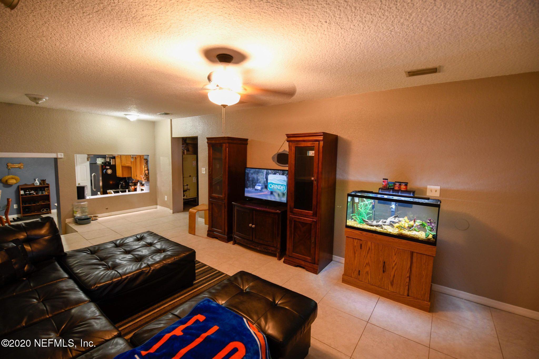 259 Brickyard Road, Unit C Middleburg, FL 32068 - Photo 7 of 17 a living room with furniture and a flat screen tv