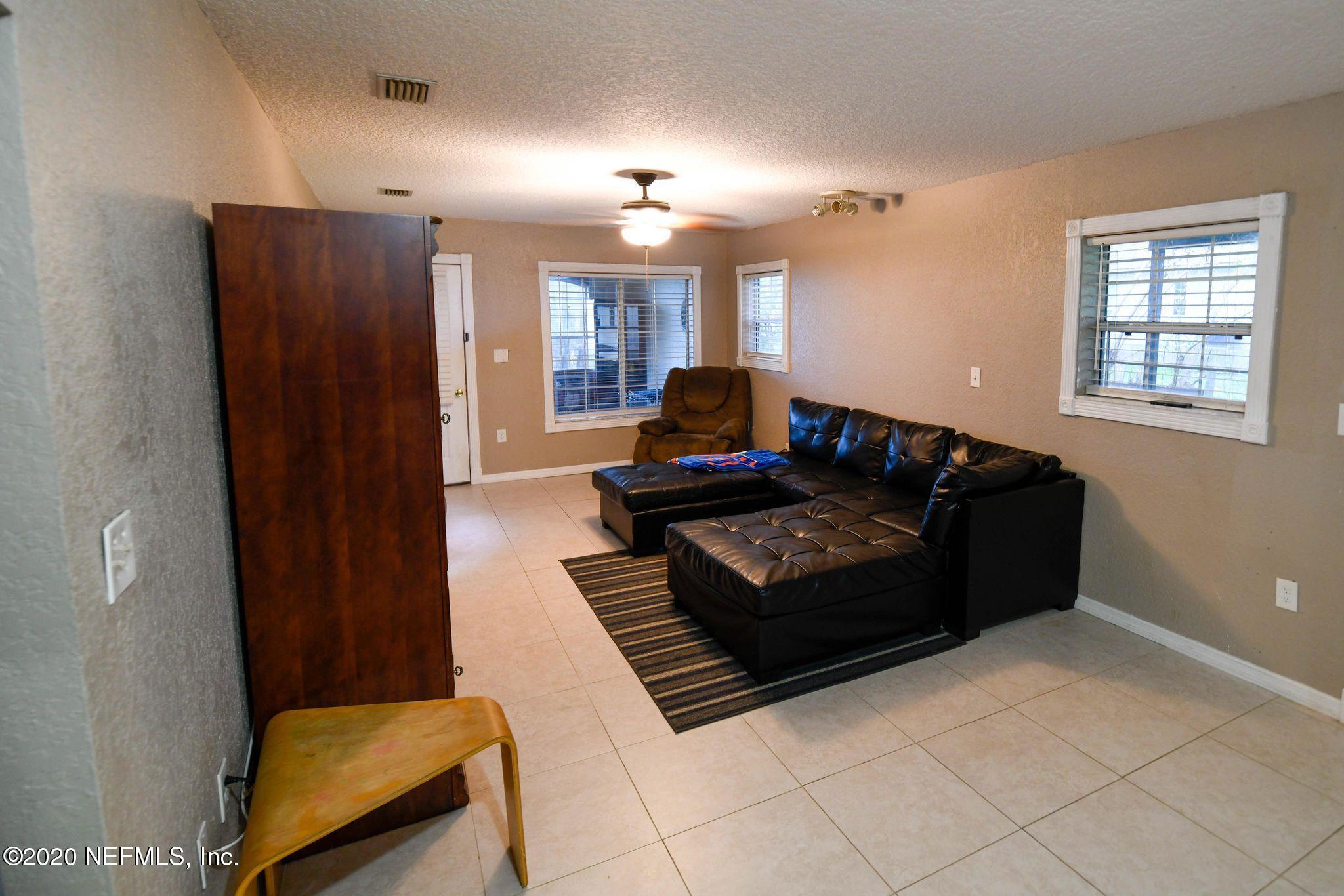 259 Brickyard Road, Unit C Middleburg, FL 32068 - Photo 8 of 17 a living room with furniture and a rug