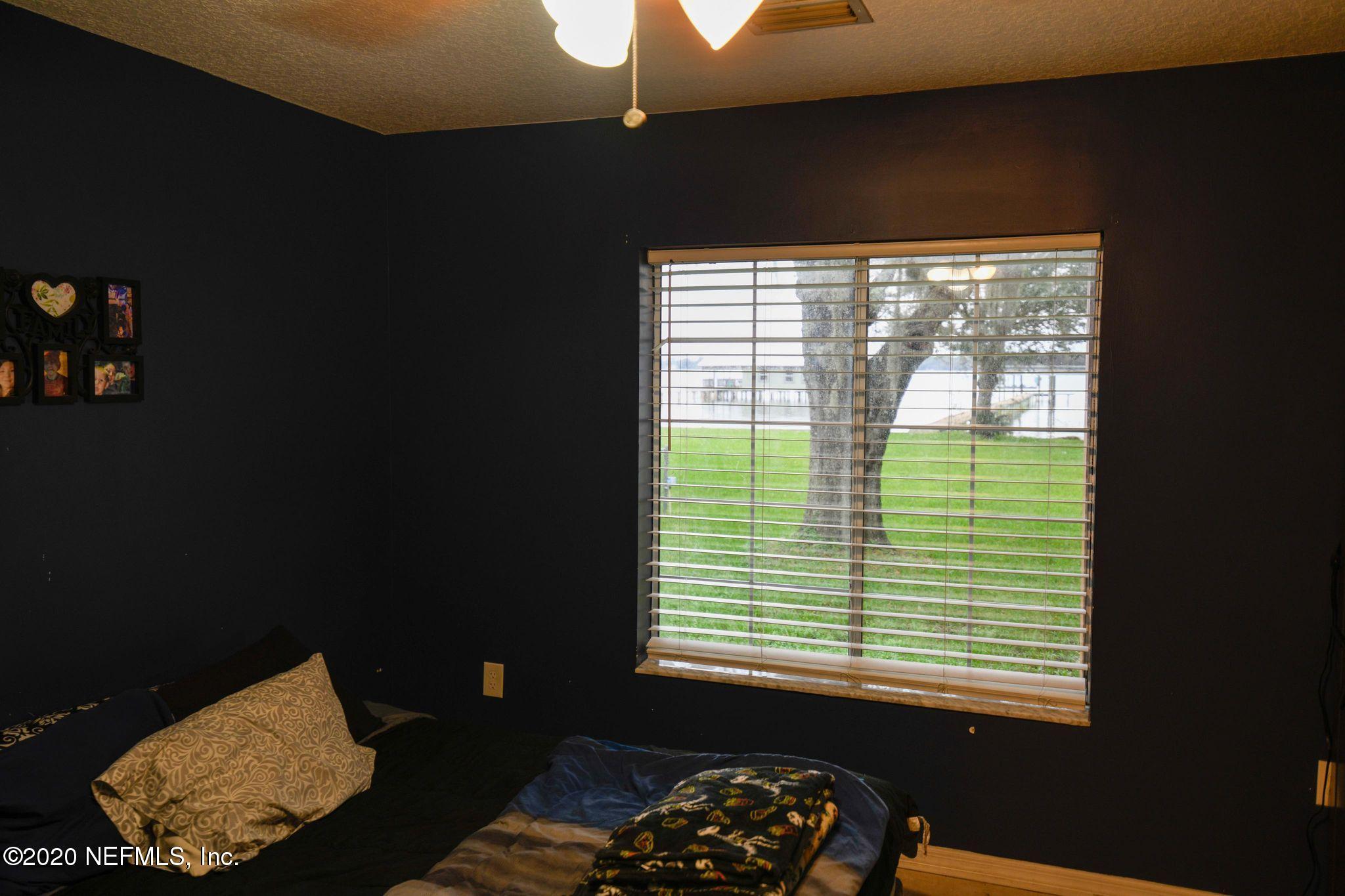 259 Brickyard Road, Unit C Middleburg, FL 32068 - Photo 10 of 17 a bedroom with a bed and a window