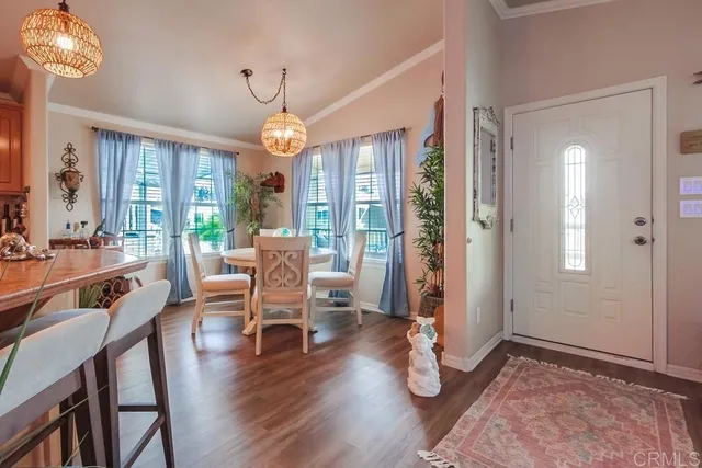 a living room with kitchen island furniture and a chandelier