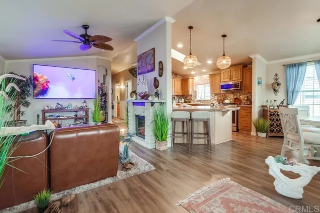 a dining room with wooden floor a chandelier a glass table and chairs