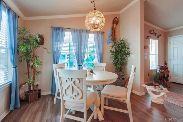 a dining room with furniture and kitchen view