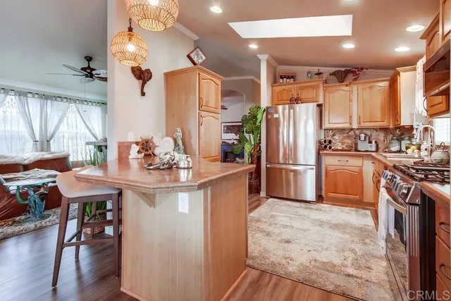 a kitchen with stainless steel appliances granite countertop a stove a sink and a refrigerator