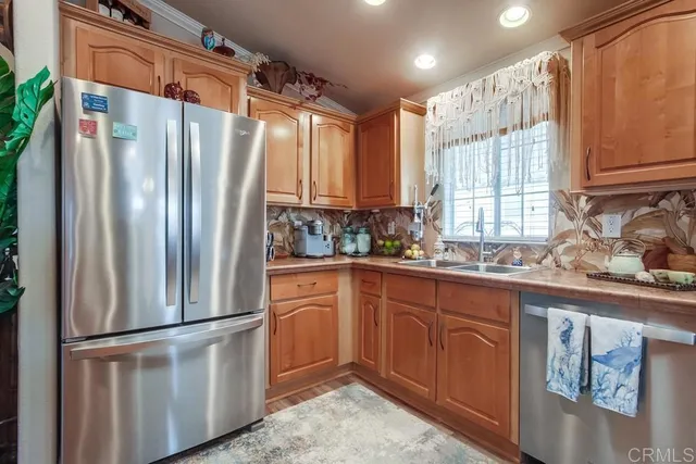 a kitchen with stainless steel appliances granite countertop a stove sink and microwave