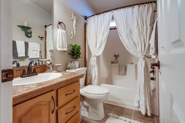 a bathroom with a toilet a sink and a mirror