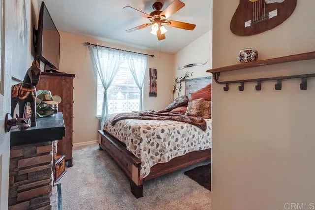 a bedroom with a bed next to a window