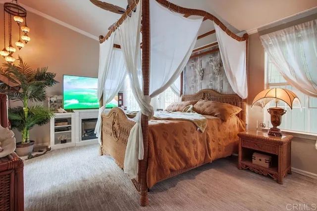 a bed sitting in a room next to a window