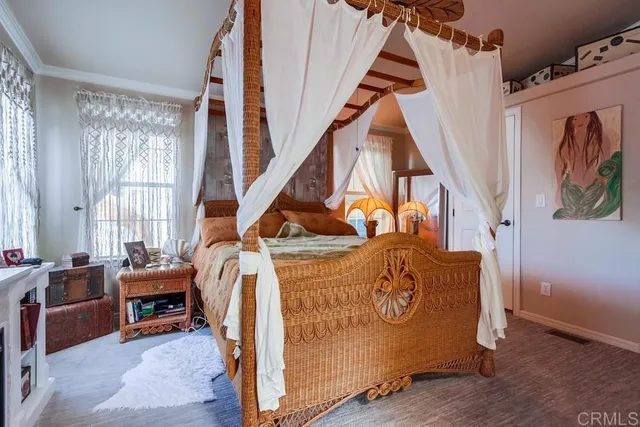 a bathroom with a granite countertop sink toilet a mirror and a window