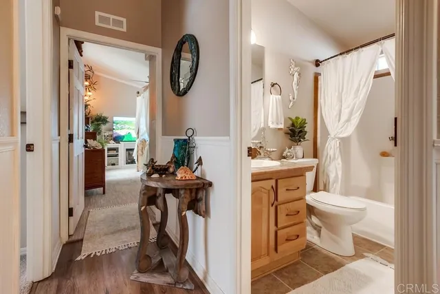 a living room with furniture a flat screen tv and a potted plant