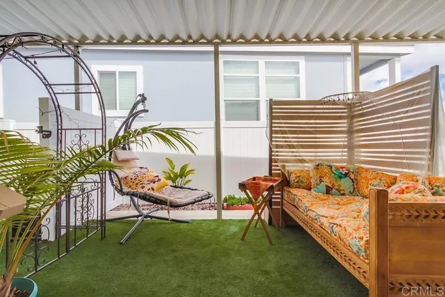 a front view of a house with a tree