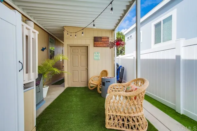 a front view of a house with a yard and fountain in middle of the road