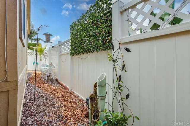 a view of a patio with table and chairs under an umbrella