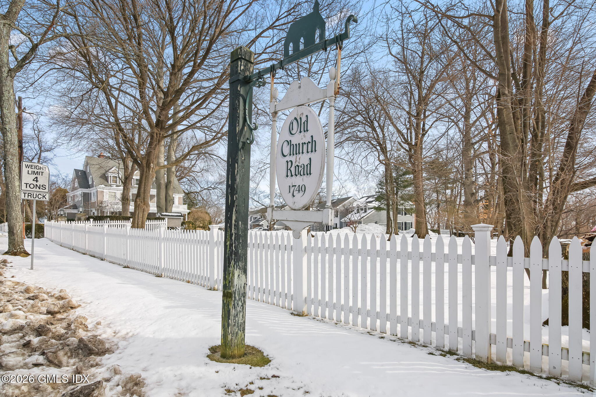 1 Old Church Road, Unit 1 Greenwich, CT 06830 - Photo 7 of 7 a street view with a wooden fence