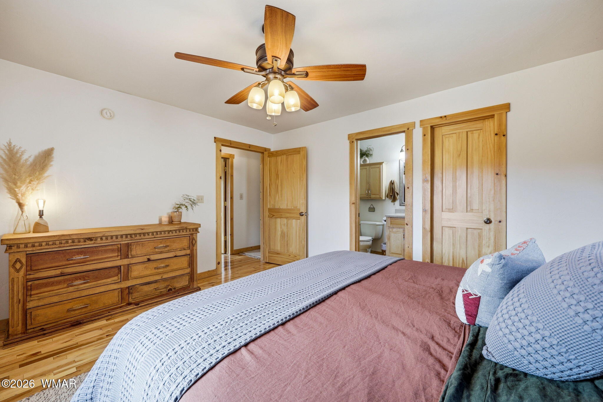 15 Co Road Nutrioso, AZ 85932 - Photo 23 of 46 a bedroom with a bed a chandelier and a dresser