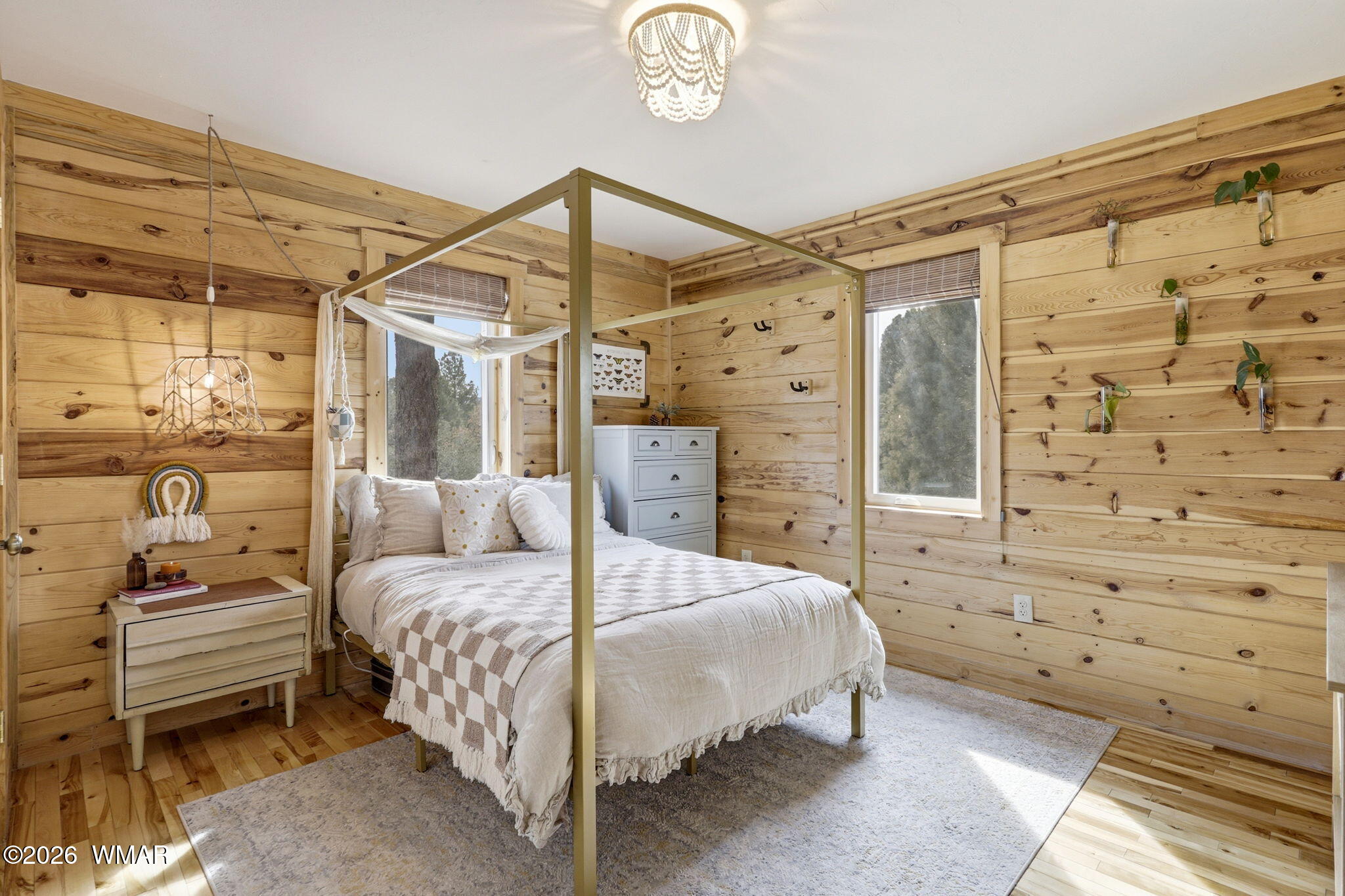 15 Co Road Nutrioso, AZ 85932 - Photo 25 of 46 a bedroom with a bed and a chandelier