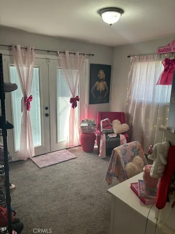 a bedroom with furniture and a window