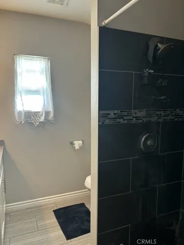 a bathroom with a glass shower door