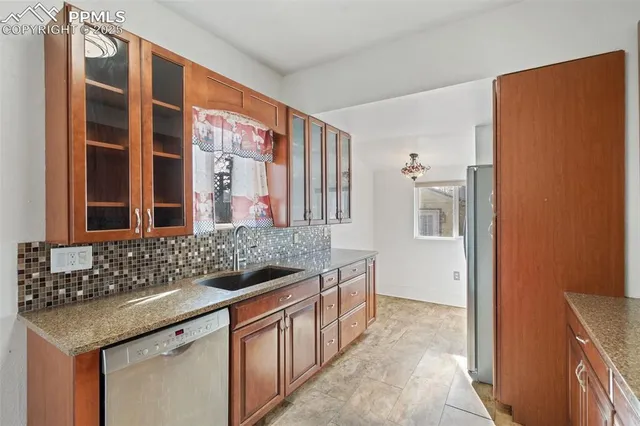 a spacious bathroom with a granite countertop sink and a mirror