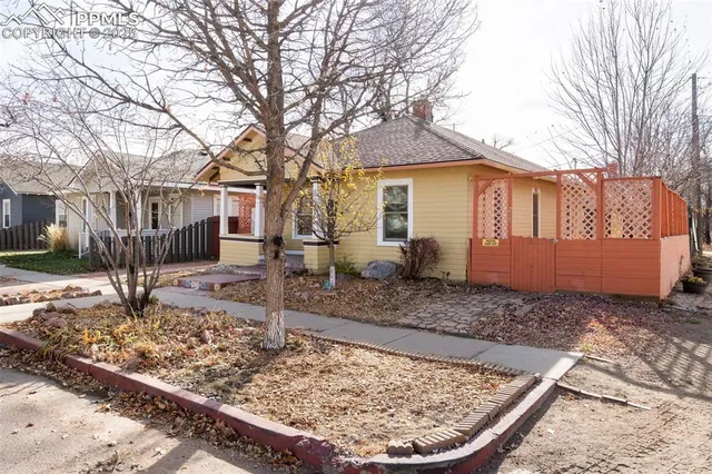 a view of a house with a yard covered in snow