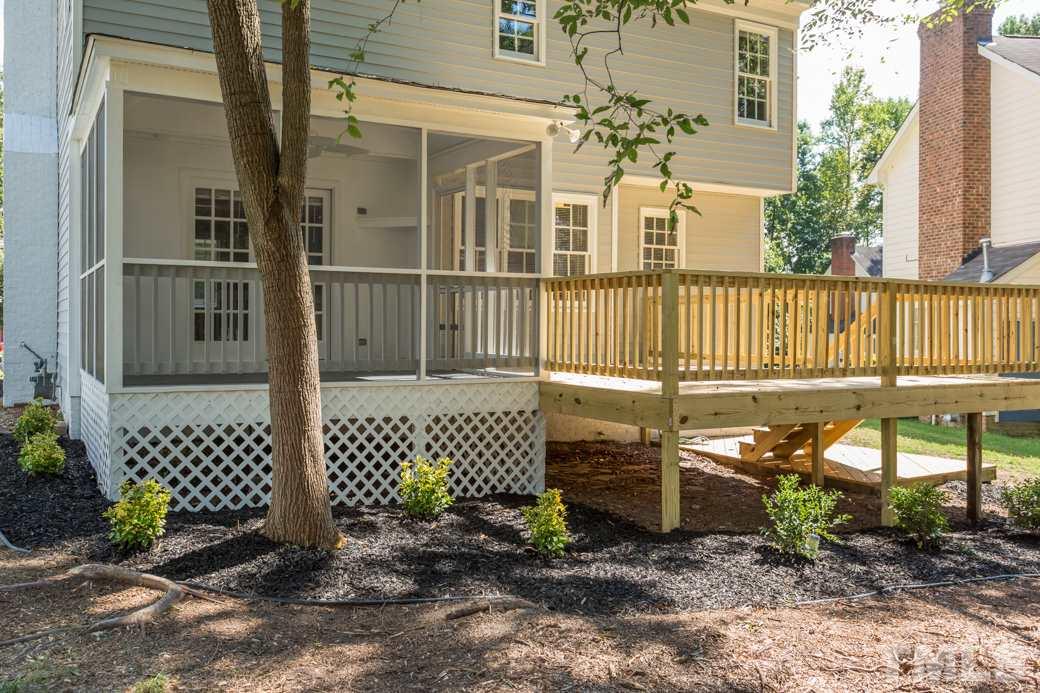 3600 East Jameson Road Raleigh, NC 27604 - Photo 13 of 15 a view of a brick house with a bench next to a yard