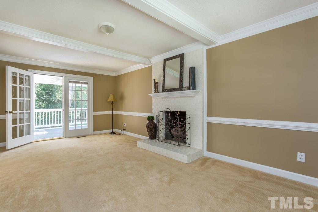 3600 East Jameson Road Raleigh, NC 27604 - Photo 6 of 15 a view of an empty room with a fireplace and a window