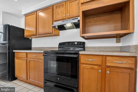 a kitchen with stainless steel appliances granite countertop cabinets and a refrigerator