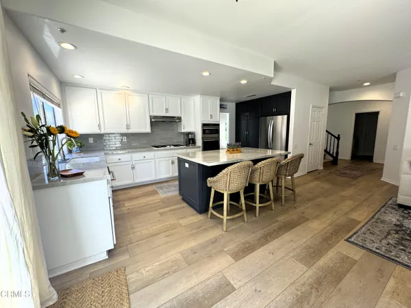 a large kitchen with a table and chairs in it