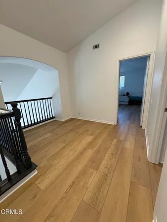 a view of a room with wooden floor