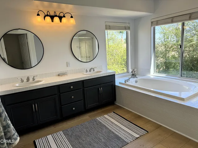 a bathroom with a double vanity sink and a mirror
