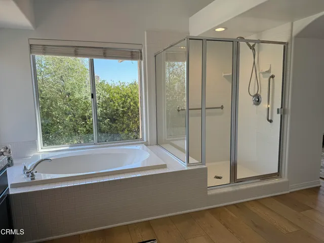a bathroom with a bathtub and a shower