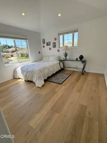 a spacious bedroom with a bed and a large window
