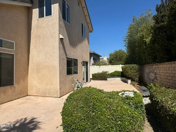 a pathway of a house with a yard