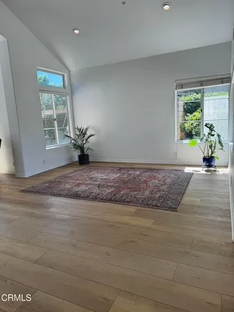 a view of a livingroom with wooden floor and a window