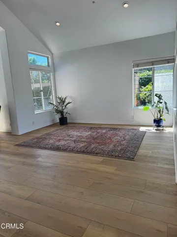 a view of a livingroom with wooden floor and a window