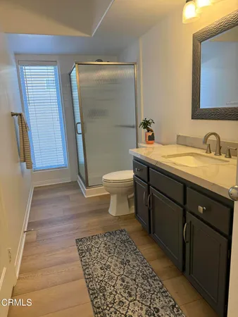 a bathroom with a sink a toilet and mirror