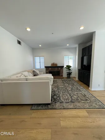a view of living room with furniture and kitchen view
