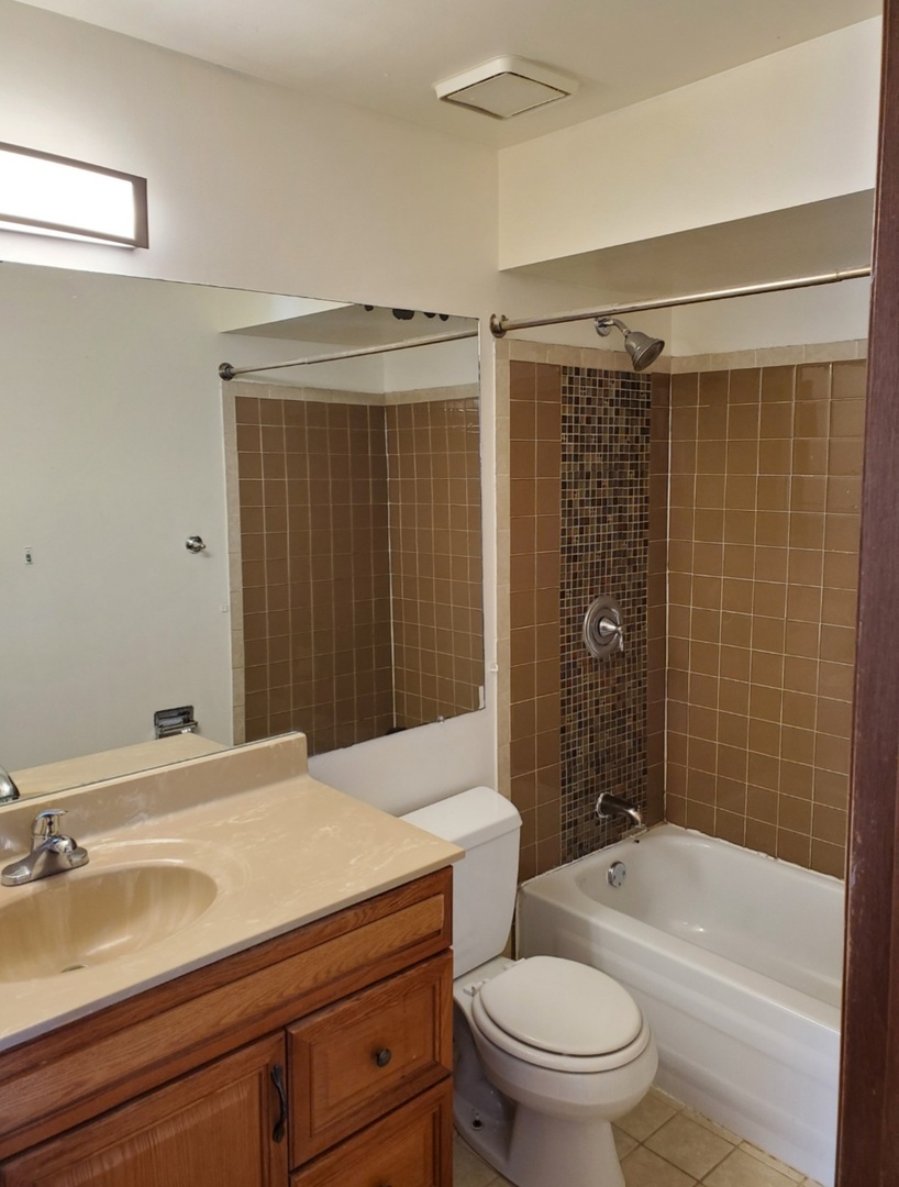 54 Churn Road Matteson, IL 60443 - Photo 14 of 19 a bathroom with a sink a toilet and shower