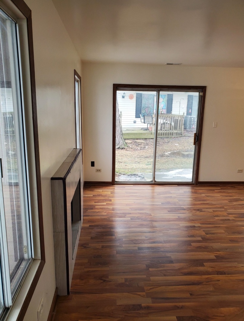 54 Churn Road Matteson, IL 60443 - Photo 3 of 19 a view of an empty room with wooden floor and a window