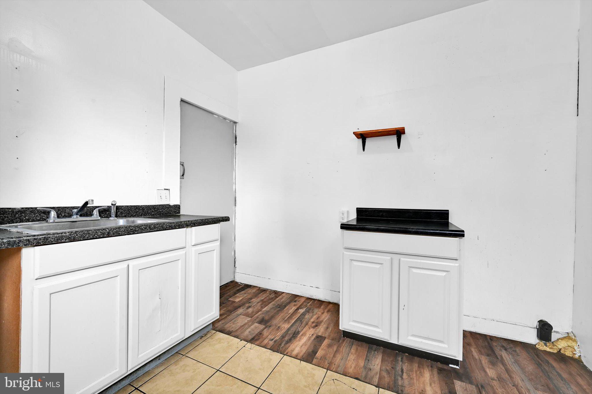525 Bingaman Street Reading, PA 19602 - Photo 11 of 27 a kitchen with granite countertop white cabinets and white appliances