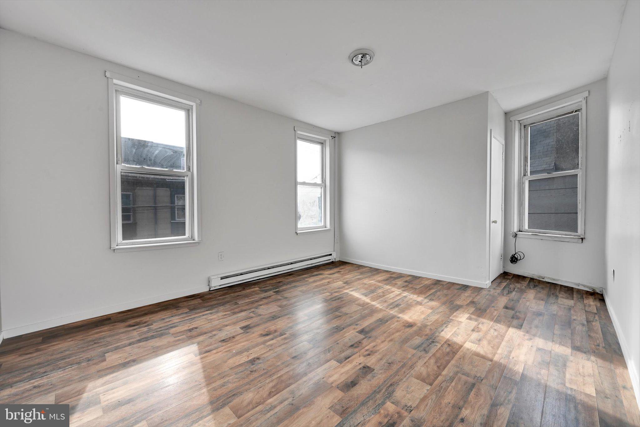 525 Bingaman Street Reading, PA 19602 - Photo 13 of 27 a view of an empty room with window and wooden floor