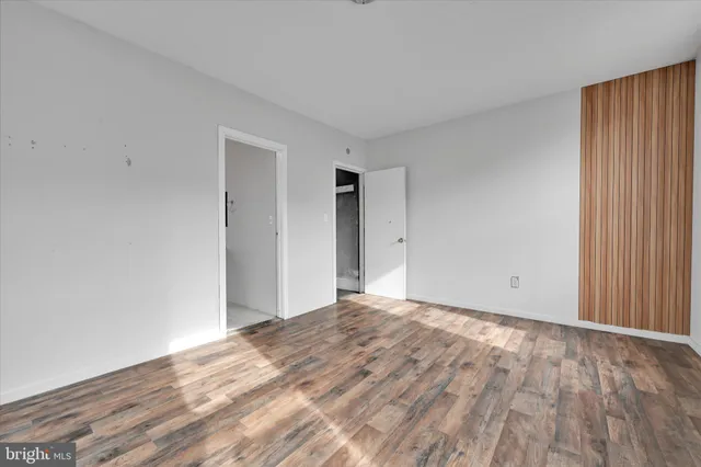 a view of an empty room and wooden floor