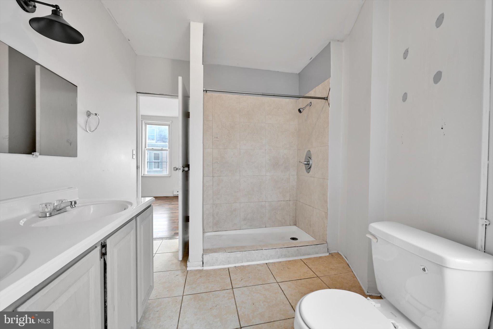 525 Bingaman Street Reading, PA 19602 - Photo 16 of 27 a bathroom with a granite countertop sink toilet and shower